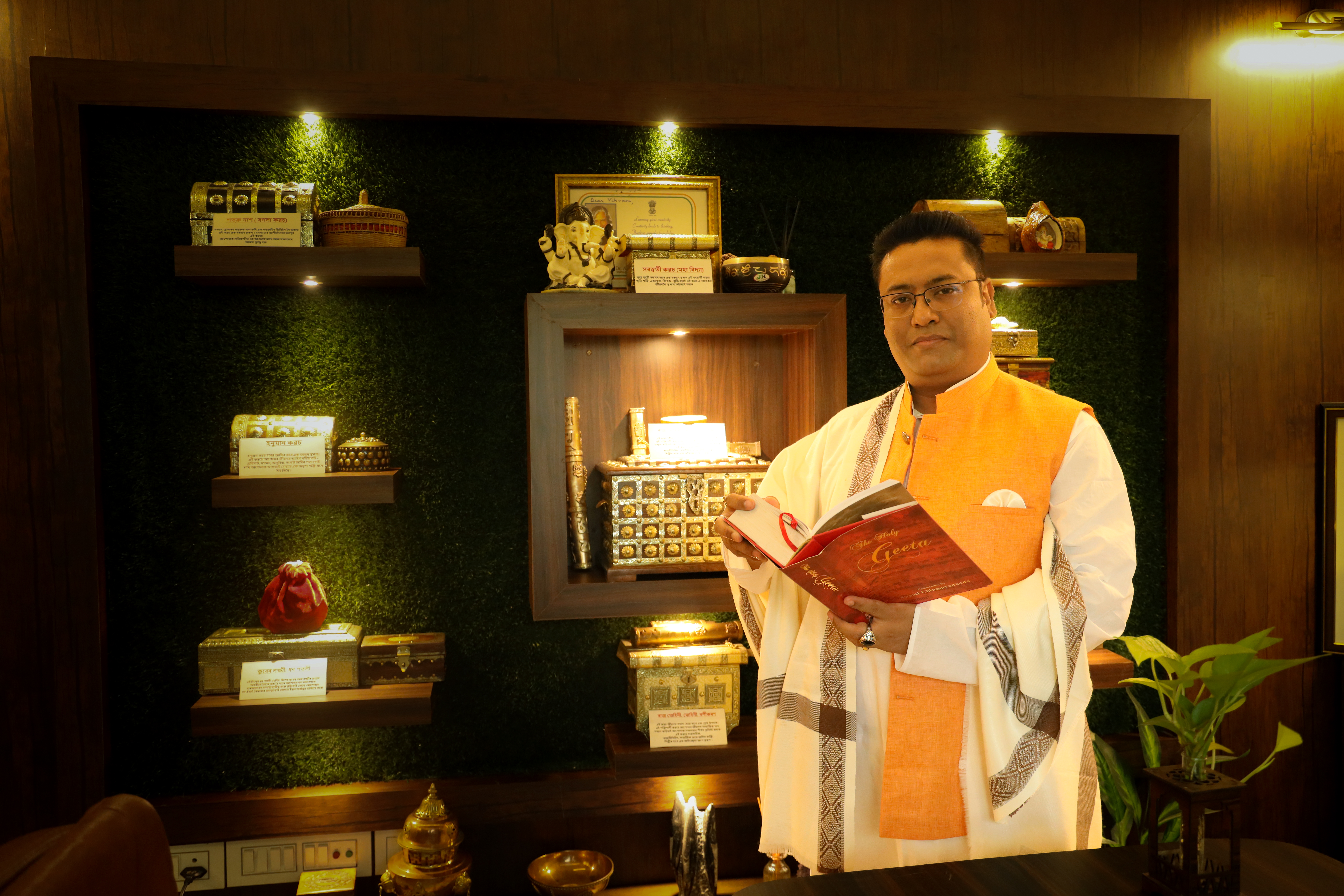 Dr. Vikram Talukdar holding the Bhagavad Gita at the centre